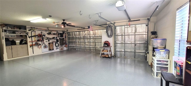 garage featuring ceiling fan and a garage door opener