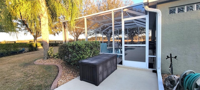 view of patio featuring glass enclosure