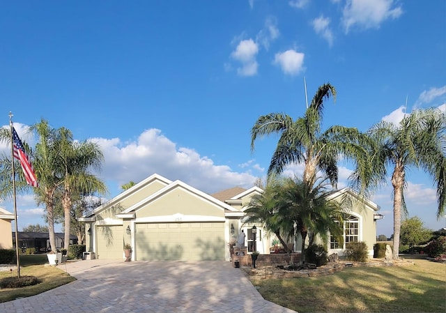 view of front of house with a garage and a front yard