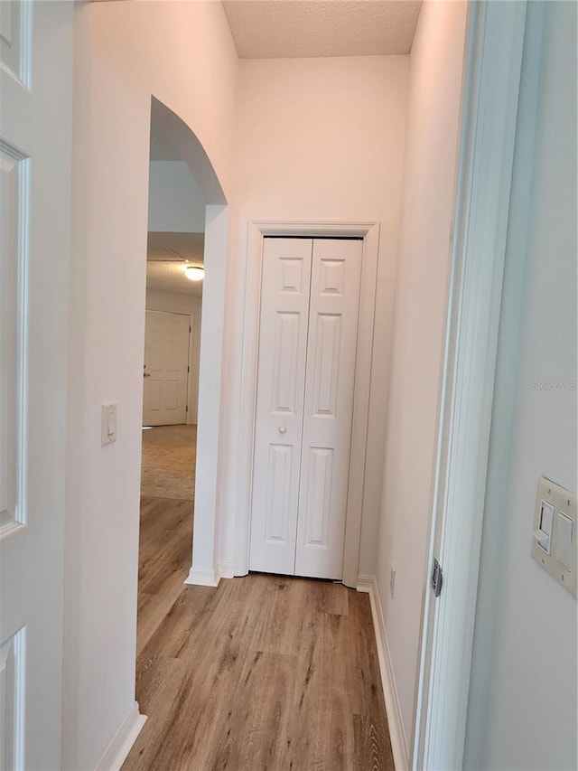 corridor with light hardwood / wood-style flooring