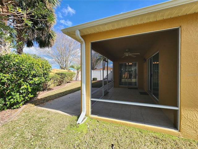 doorway to property featuring ceiling fan and a patio area