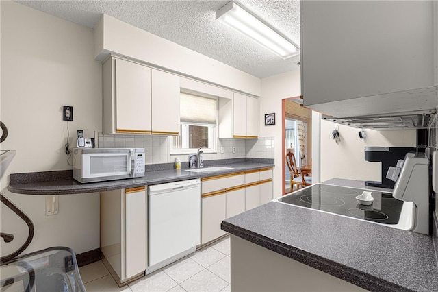 kitchen featuring white cabinetry, white appliances, sink, and decorative backsplash