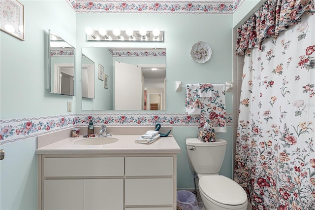 bathroom featuring vanity, toilet, and a shower with shower curtain