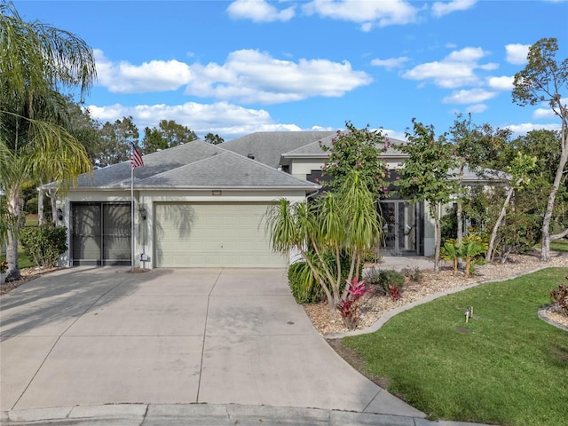 view of front of home featuring a front yard and a garage