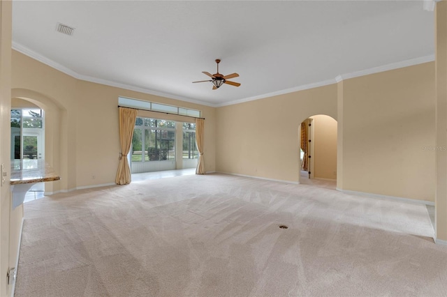 carpeted spare room featuring ceiling fan and crown molding