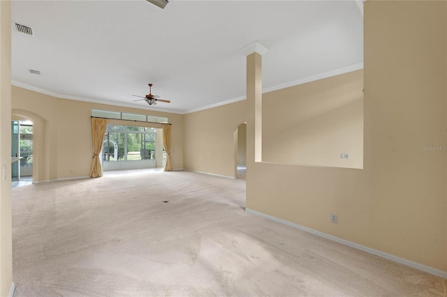 carpeted empty room with ceiling fan and ornamental molding