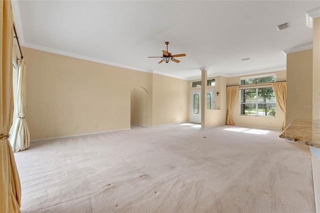 carpeted spare room featuring ceiling fan and ornamental molding