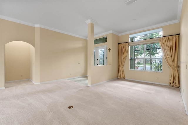 empty room featuring light colored carpet and ornamental molding