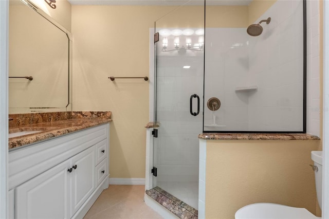 bathroom featuring toilet, vanity, tile patterned flooring, and a shower with shower door