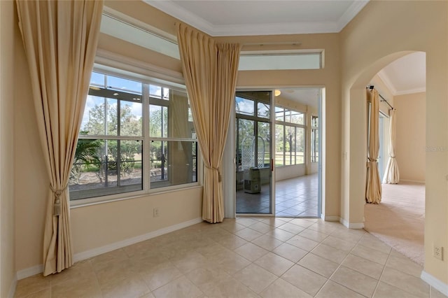 doorway featuring ornamental molding and light tile patterned floors