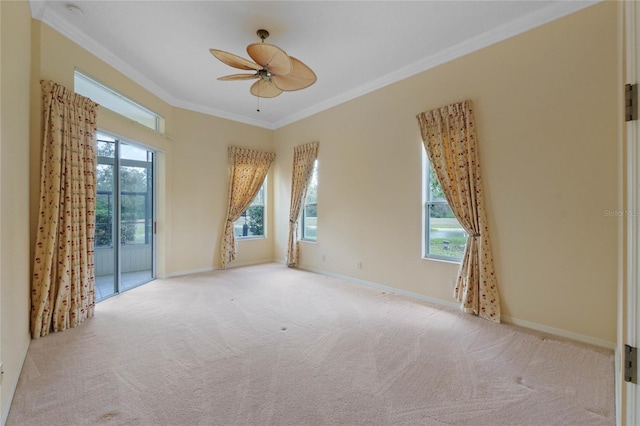 carpeted spare room featuring crown molding and ceiling fan