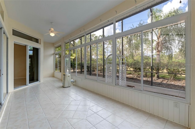 unfurnished sunroom with ceiling fan and a wealth of natural light