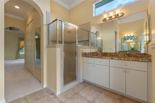 bathroom with crown molding, tile patterned flooring, vanity, and walk in shower