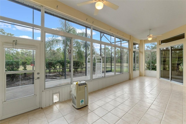 unfurnished sunroom featuring ceiling fan