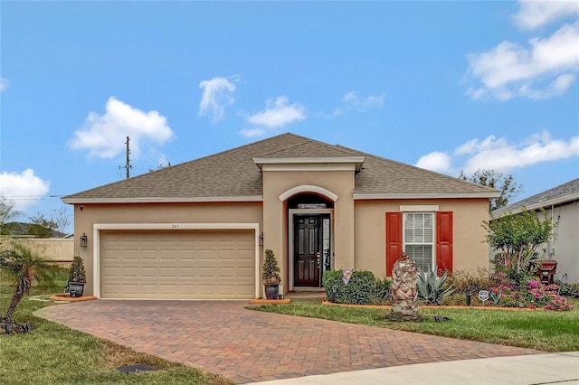 view of front of house featuring a garage and a front yard