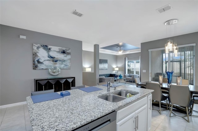 kitchen featuring ceiling fan with notable chandelier, decorative light fixtures, dishwasher, white cabinetry, and sink