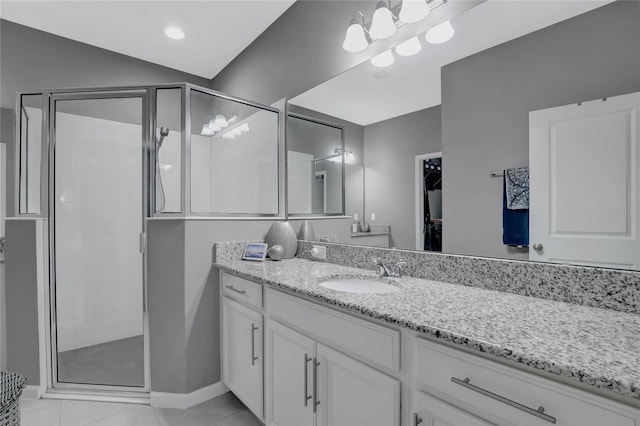 bathroom with tile patterned floors, vanity, and a shower with door