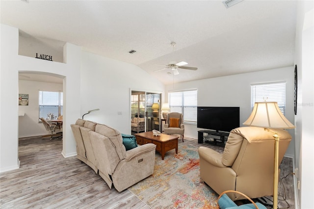 living room with light hardwood / wood-style flooring, vaulted ceiling, and ceiling fan