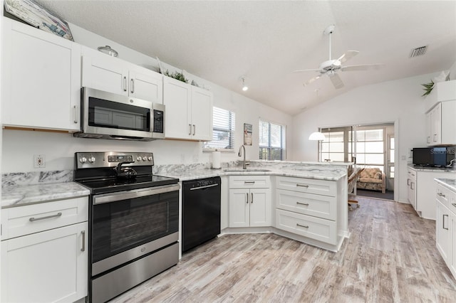kitchen featuring white cabinetry, sink, stainless steel appliances, and kitchen peninsula