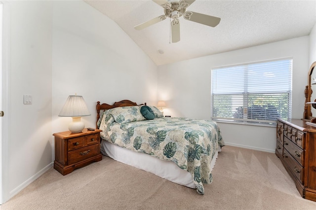 bedroom with ceiling fan, lofted ceiling, and light carpet