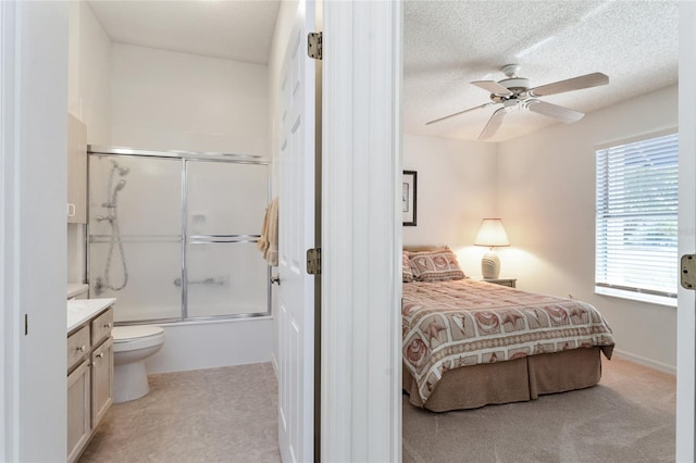 bedroom with ceiling fan and a textured ceiling