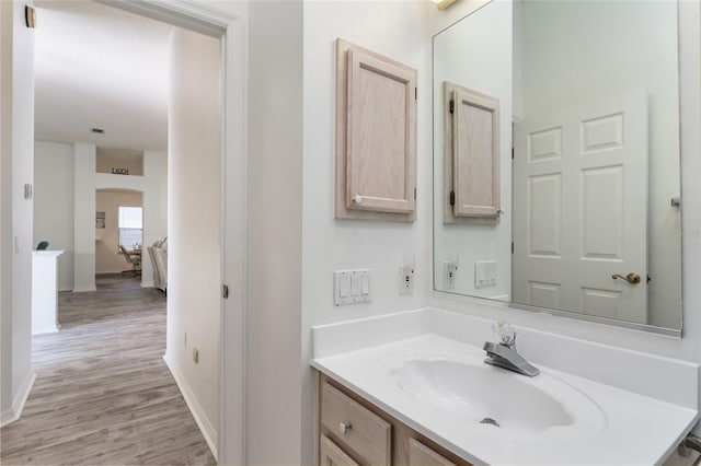 bathroom with vanity and hardwood / wood-style floors