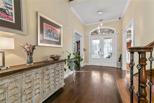 entryway featuring baseboards, hardwood / wood-style flooring, stairway, ornamental molding, and french doors