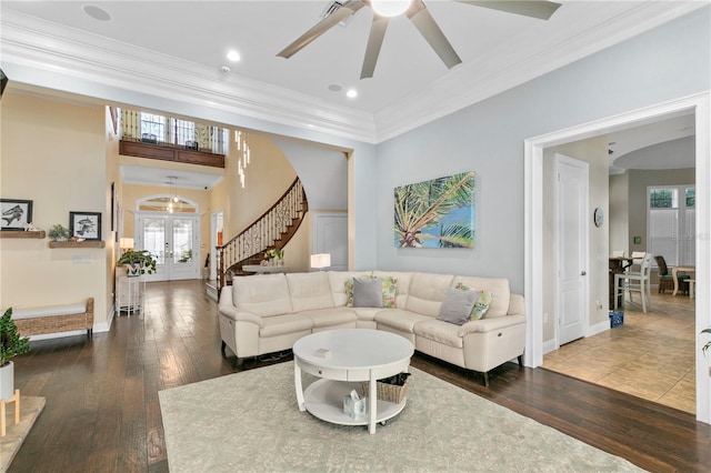 living room with stairs, french doors, ornamental molding, and hardwood / wood-style floors