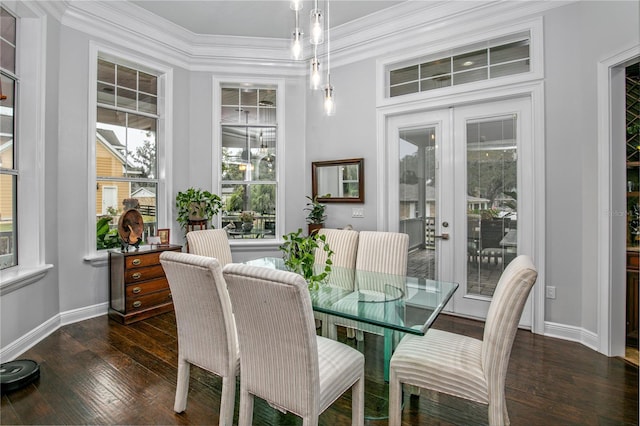 dining area with dark wood-style floors, french doors, ornamental molding, and baseboards