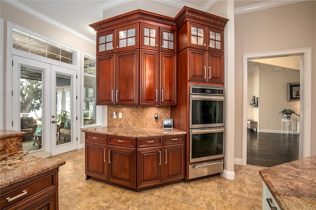 kitchen featuring glass insert cabinets, crown molding, double oven, backsplash, and a warming drawer