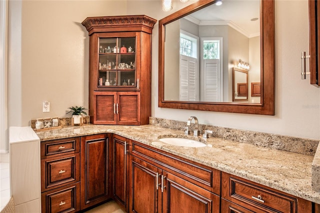 bathroom with ornamental molding and vanity