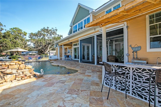 view of pool featuring french doors, a patio area, fence, and a fenced in pool