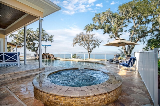 view of pool featuring a water view, a fenced in pool, and a patio