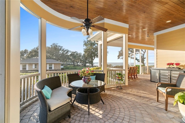 exterior space featuring wood ceiling and a ceiling fan