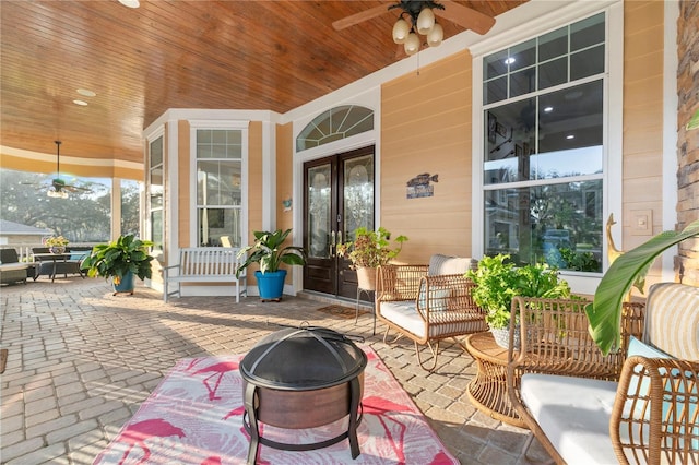 view of patio / terrace featuring ceiling fan, french doors, and covered porch