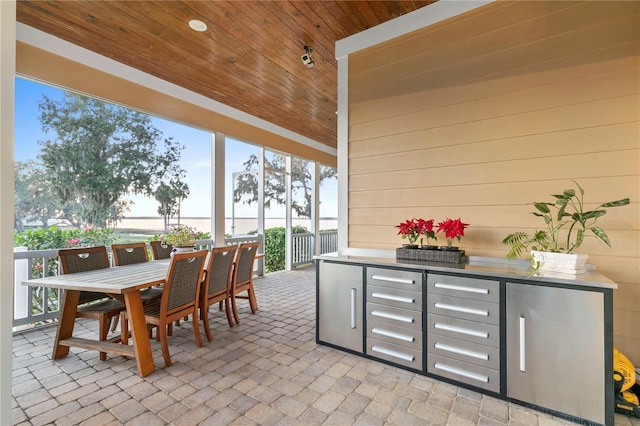 sunroom / solarium featuring wood ceiling