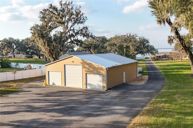 detached garage featuring fence