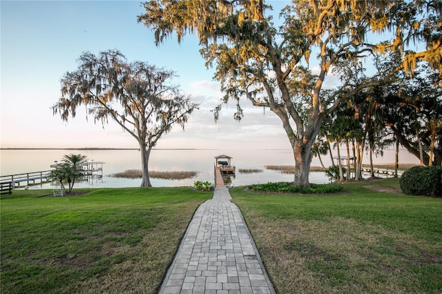 surrounding community featuring a yard and a water view