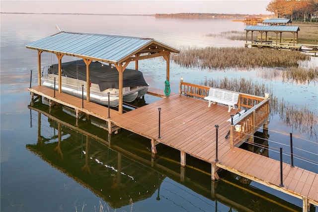 dock area with a water view and boat lift