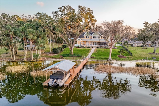 dock area featuring a yard and a water view