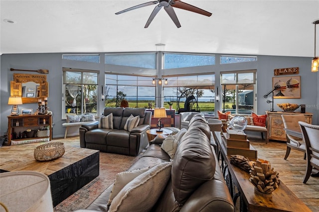 living room featuring vaulted ceiling, light hardwood / wood-style floors, and ceiling fan