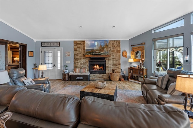 living room with hardwood / wood-style flooring, a healthy amount of sunlight, and vaulted ceiling