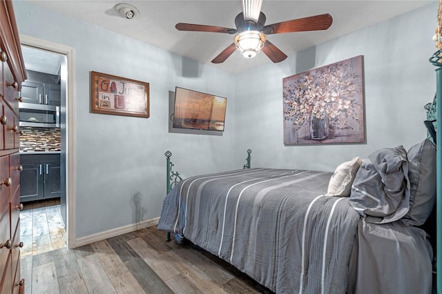 bedroom with ceiling fan and wood-type flooring