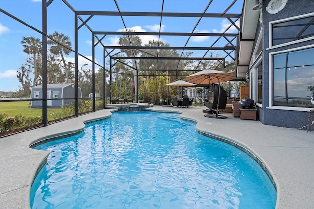 view of pool with a patio, a lanai, and an in ground hot tub