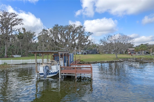 view of dock with a water view and a yard