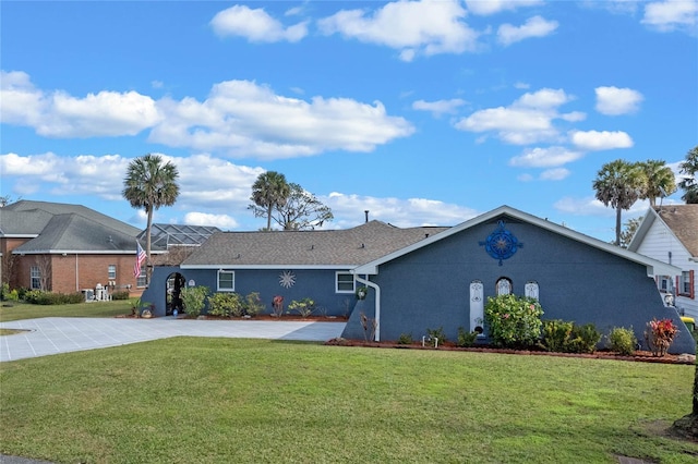 ranch-style house with a front lawn and glass enclosure