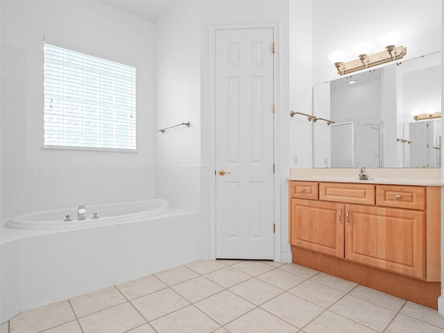 full bathroom with a bath, a shower stall, tile patterned flooring, and vanity