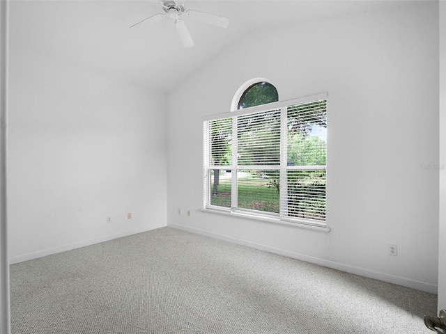 spare room with lofted ceiling, baseboards, a ceiling fan, and carpet floors