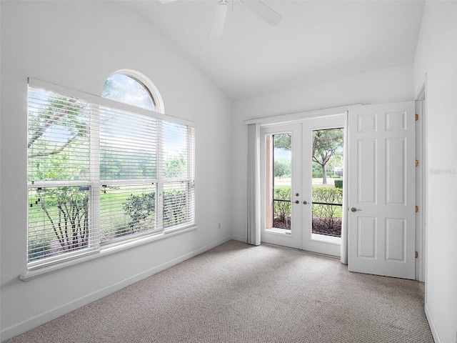spare room with french doors, light colored carpet, ceiling fan, and vaulted ceiling