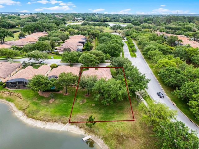 drone / aerial view with a water view and a residential view